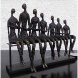 CONTEMPORARY SCHOOL FAMILY FIGURES, seated in a bronzed resin base, 40cm W.