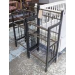 BOOK RACKS, a pair, the ebonised wooden frames with slanted tubular metal shelves,