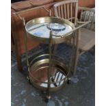 COCKTAIL TROLLEY, 1960's French style, gilt metal with two circular mirrored tiers, 74cm H x 52cm W.