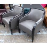 CONTEMPORARY ARMCHAIRS, grey leather with ebonised showframes, each 65cm W x 83cm H.