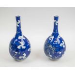 CHINESE BOTTLE VASES, a pair, blue and white porcelain, 25cm H.