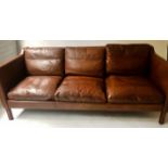 SOFA, 1970's Danish teak and hand dyed mid brown grained leather with three seat and back cushions,