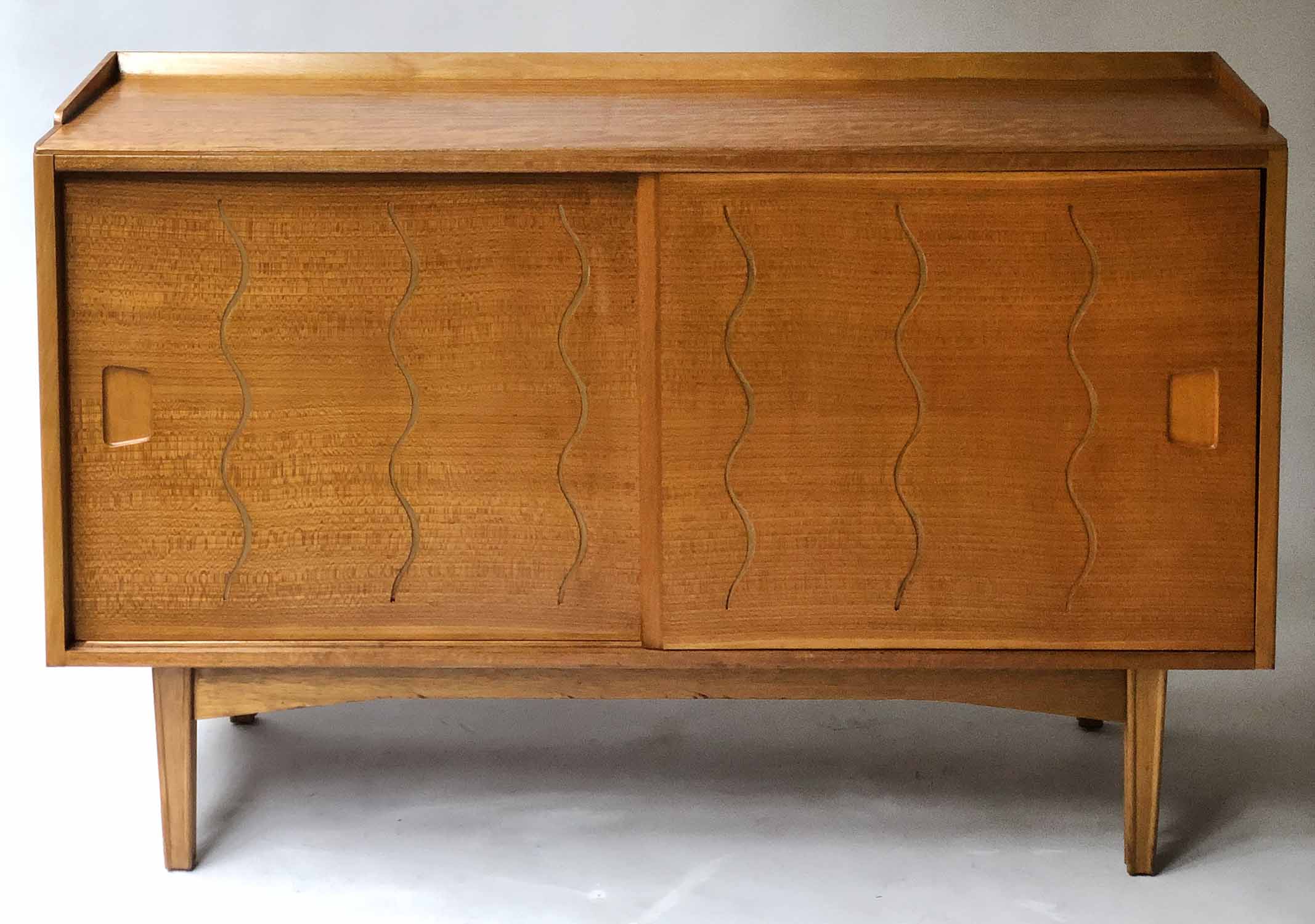 SIDEBOARD BY IAN AUDSLEY FOR G W EVANS, mid 20th century walnut and elm with sliding doors,