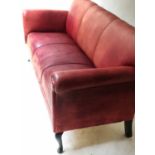 LEATHER SOFA, 20th century faded red leather, three seater with shaped supports, 180cm W.
