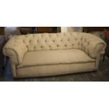 CHESTERFIELD SOFA, early 20th century in patterned cream material on castors, 207cm W.