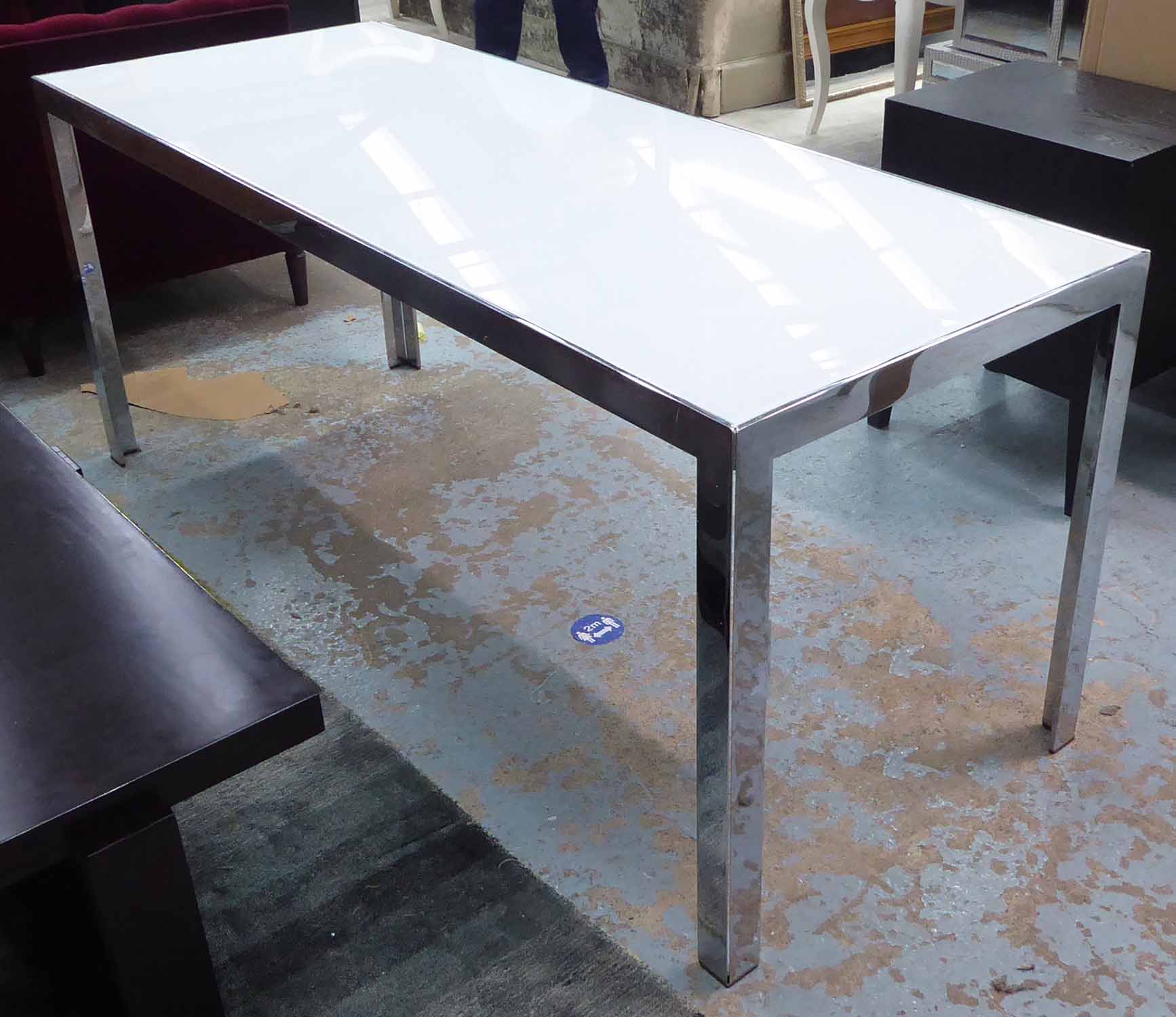 TABLE, opaque glass top, polished metal base, 67cm D x 172cm L x 74cm H.