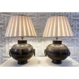 TABLE LAMPS, a pair, converted from vintage Indian water carriers, hand beaten metal, with shades,