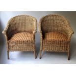 CANE ARMCHAIRS, a pair, two tone cane with rounded backs and arched supports, 68cm W.