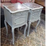 BEDSIDE CABINETS, two similar late 19th century French distressed cream painted,