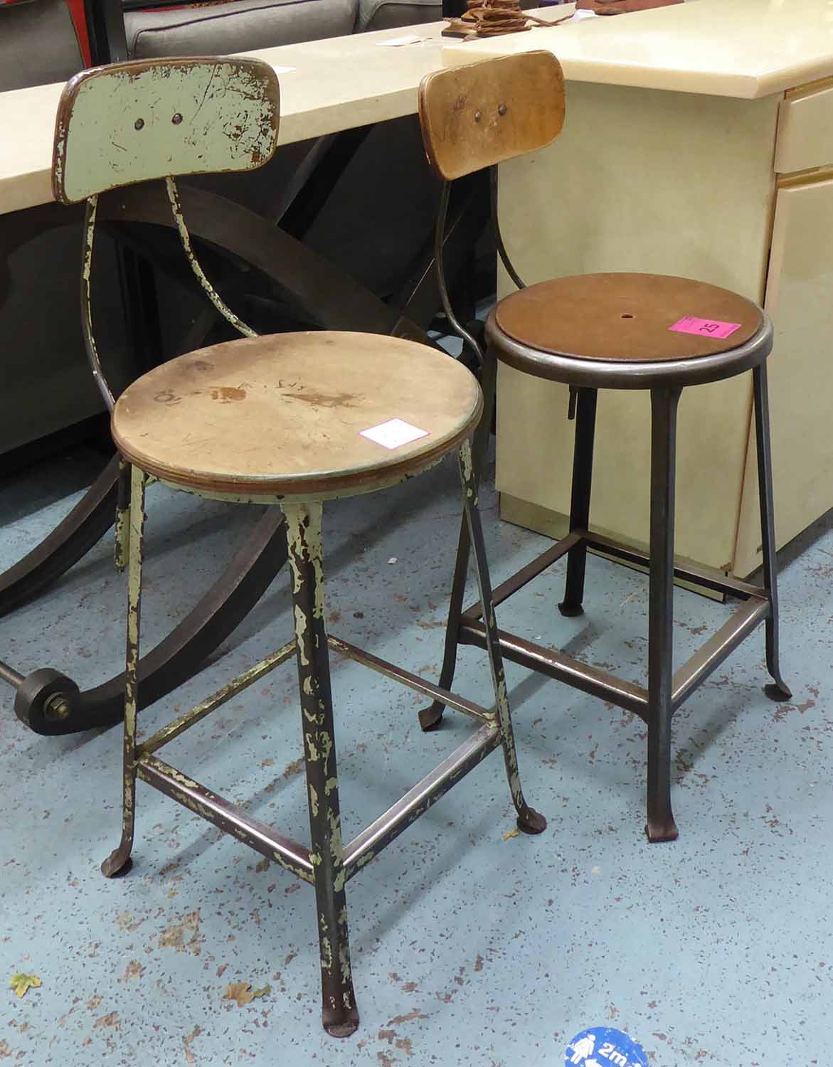 VINTAGE WORK STOOLS, two, of differing design, 95cm at highest.