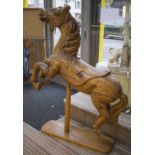 CAROUSEL HORSE, 19th century French pine on later stand, 145cm H x 102cm L.