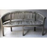 BANANA GARDEN SEAT, silvery weathered teak of bowed form and slatted construction, 160cm W.