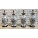 TABLE LAMPS, two pairs, Chinese ceramic vase form with carved hardwood bases, largest 42cm H.