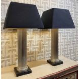 ATTRIBUTED TO ANDREW MARTIN COLUMN LAMPS, a pair, with shades, 90cm H.