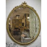 WALL MIRROR, mid Victorian giltwood, with oval plate in a cabochon and guilloche frame,