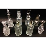 DECANTERS, eight, cut glass and crystal including a pair with lozenge faceted stoppers,