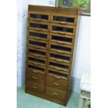 HABERDASHERY CABINET, oak with fourteen glazed fronted drawers above four drawers,