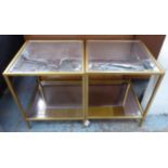 HOLLYWOOD REGENCY STYLE SIDE TABLES, a pair, bevelled glass tops, with under tiers,