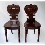 HALL CHAIRS, a pair, William IV mahogany each with scroll back and panel seat.
