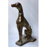 GREYHOUND, a composition model of a seated greyhound with silvered collar, 76cm H.
