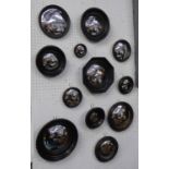 CONVEX WALL MIRRORS, a set of twelve, Regency style, various sizes and shapes, ebonised finish,