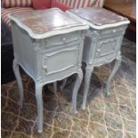 BEDSIDE CABINETS, two similar late 19th century French distressed cream painted, each with a rouge
