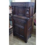 COURT CUPBOARD, Jacobean style oak, with two doors, carved details and a pair of turned columns,