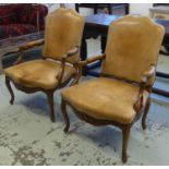 FAUTEUILS, a pair, Régence style walnut in light tan leather, 96cm H x 66cm W. (2) (with faults)