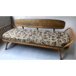 ERCOL SURFBOARD SOFA/DAYBED, 1970s Ercol elm with detachable solid elm oval back and outswept
