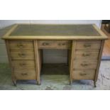 KNEEHOLE DESK, Edwardian stripped oak with green leather top above nine drawers on castors, 77cm H x