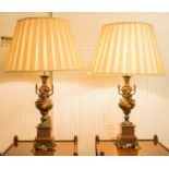 TABLE LAMPS, a pair, circa 1890, French patinated and gilt metal in the form of urns with cherub