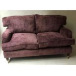 HOWARD STYLE SOFA, lavender velvet upholstered with turned front supports and castors, 170cm W.