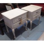 BEDSIDE CHESTS, a pair, in the French manner in a distressed cream painted finish, each with two