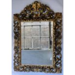 FLORENTINE WALL MIRROR, 19th century carved giltwood the bevelled plate within a pierced foliate