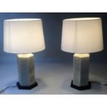 RETICULATED LAMPS, a pair, Chinese hexagonal pierced ivory coloured ceramic on wooden stands, 70cm H