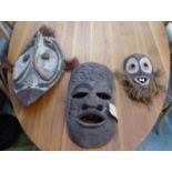 AFRICAN MASKS, a collection of three, of various descriptions, 64cm x 30cm at largest. (3)