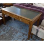 WRITING DESK, George V oak with two drawers and leather top, bears stamp on each handle, 137cm x