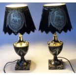 TOLEWARE LAMPS, a pair, black toleware of urn form with shades, 40cm H. (2)