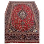 FINE PERSIAN KASHAN MEDALLION CARPET, 294cm x 203cm, ruby palmette and vine field.