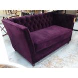 SOFA, with a buttoned back, inner sides and purple upholstery on short turned supports, 154cm L x