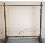 CLOTHES RAIL, 19th century French beechwood with metal rail on castors, (bears label E. Girard