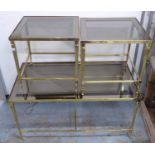 MAISON JANSEN STYLE COCKTAIL TABLES, nesting set of three, gilt metal and glass, 91cm x 48cm x