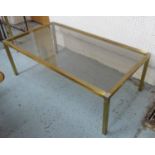 LOW TABLE, 1970's, brass with a lightly smoke glass top with polished metal corners, 58cm D x 38cm H