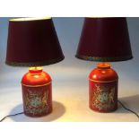 TEA CANISTER TOLEWARE LAMPS, a pair, claret red toleware with coat of arms crest and matching shade,