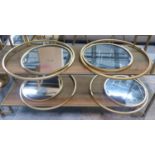 WALL MIRROR, a set of four, circular, gilt metal frames. (4)