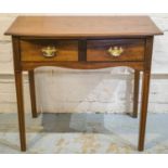 WRITING TABLE, George III mahogany with bowed top above two drawers with a silvered and brass