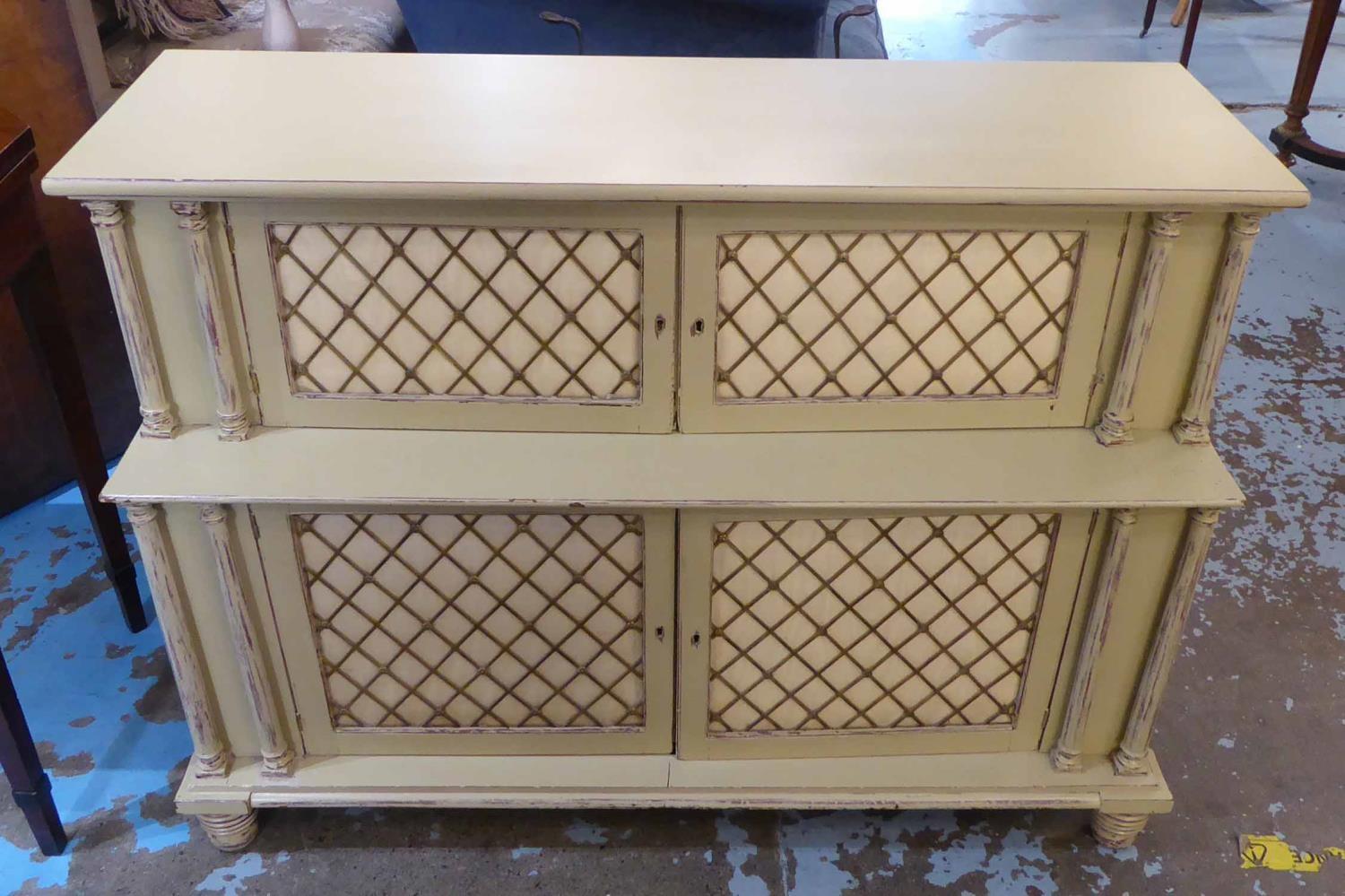 SIDE CABINET, Regency style painted of two graduated tiers with brass grille doors, 110cm W x 79cm H