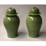 TEMPLE JARS, a pair, Chinese leaf green ceramic vases of ginger jar form with lids, 54cm H. (2)