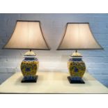 TABLE LAMPS, a matched pair, Chinese blue and yellow ceramic temple jar form on ebonised bases