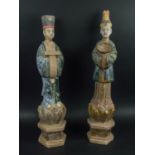 COURT FIGURES, two terracotta Ming style in Sancai glaze, posed holding offerings on hexagonal
